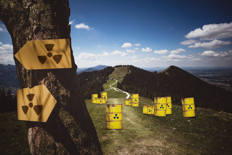 Composite image of yellow barrels with radioactive warning symbol