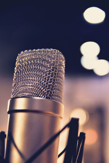 Close-up of microphone against defocused lights