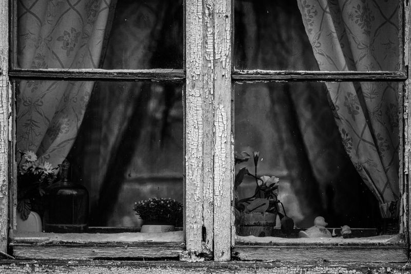 Abandoned building seen through glass window