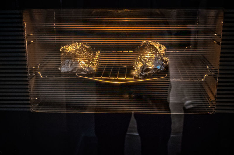 Reflection of person on toaster oven glass in kitchen