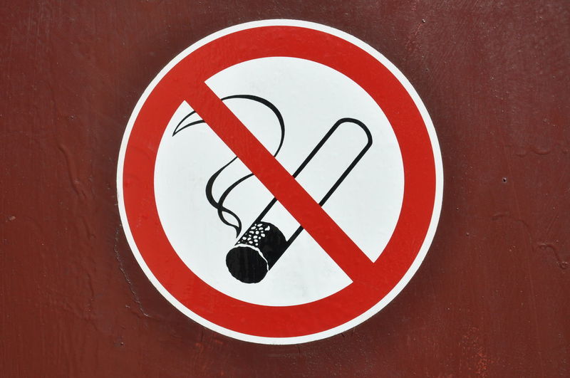 Close-up of no smoking sign on wall