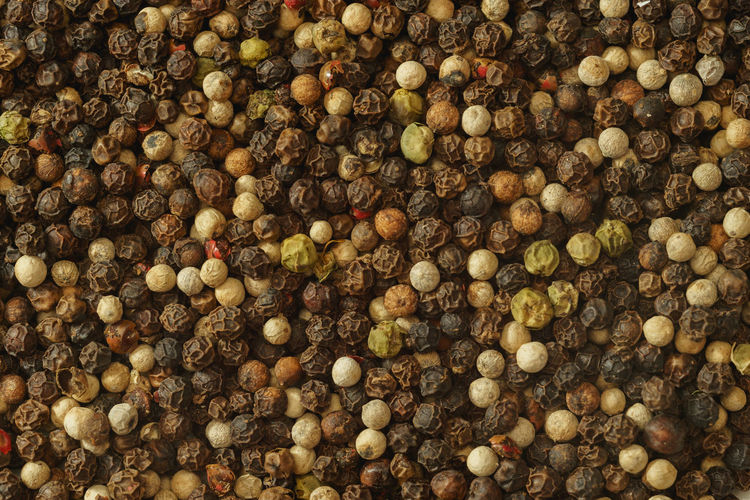 Mixed peppercorns background close-up