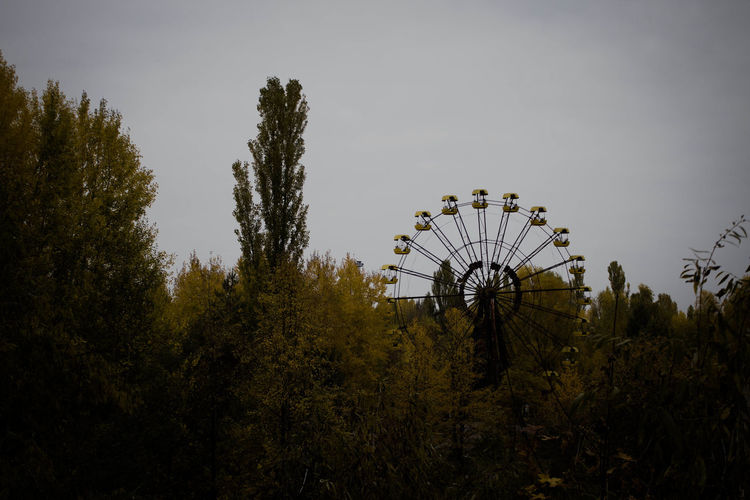Low angle view of ferris wheel against sky