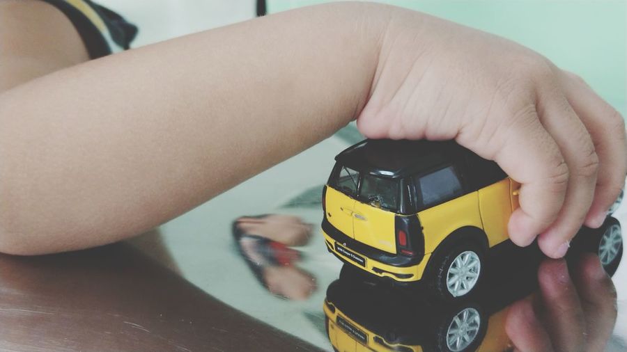 Close-up of hand holding toy car