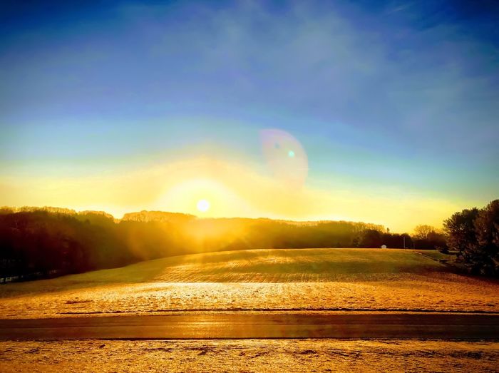 Scenic view of landscape against sky during sunset