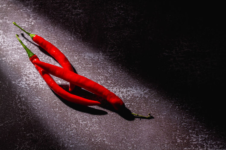 High angle view of red chili peppers on floor