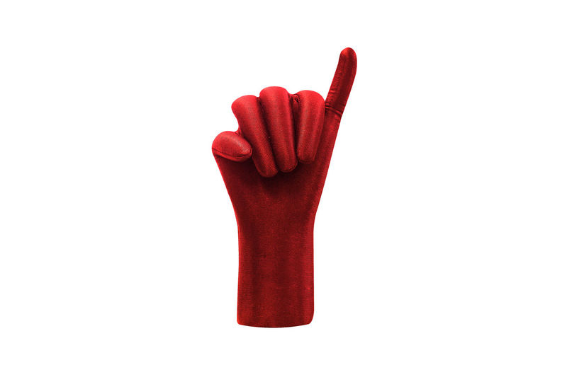 Close-up of red glove against white background