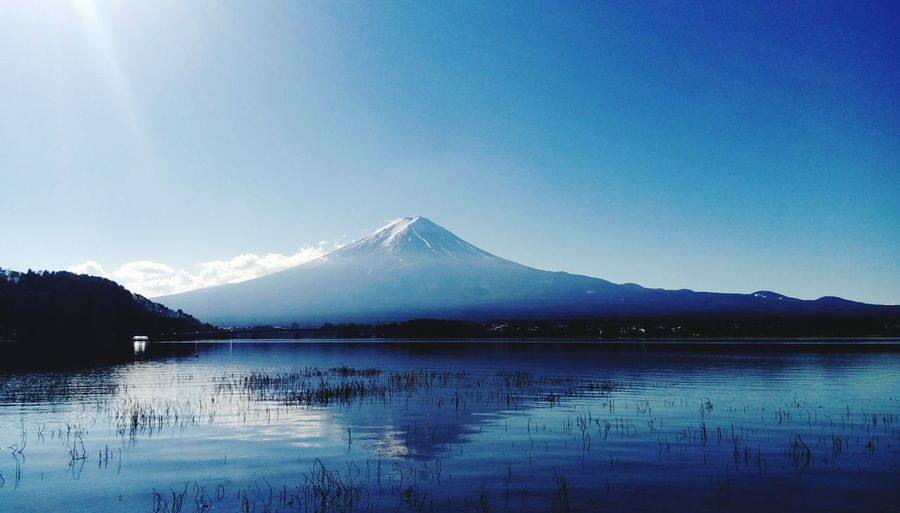 Scenic view of mt fuji reflection in lake kawaguchi against sky