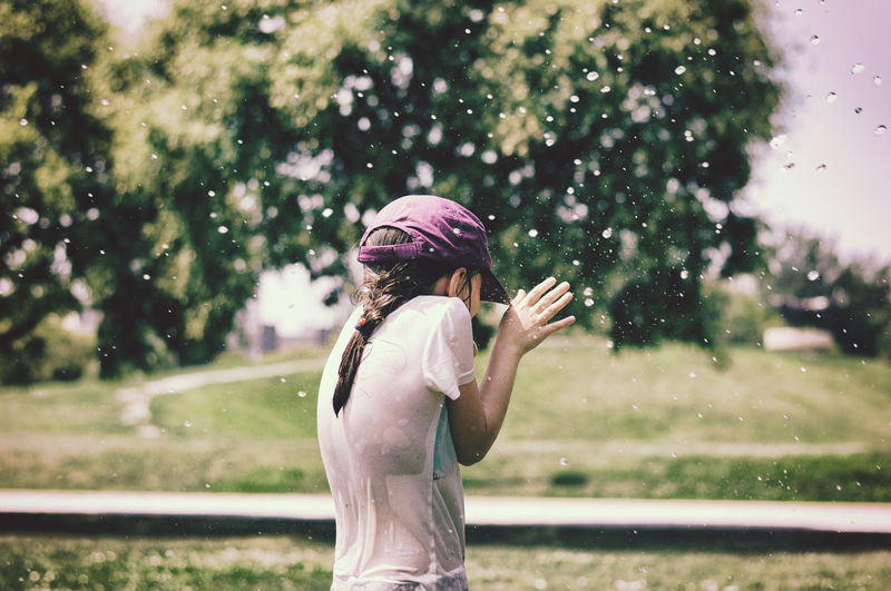 Girl getting splashed with water