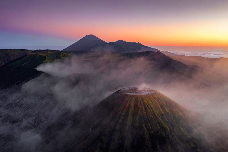 Scenic view of volcano against clear sky during sunset