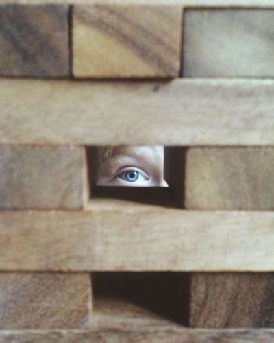 Person looking through block hole