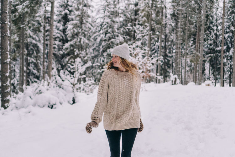 View of woman walking on snow covered land
