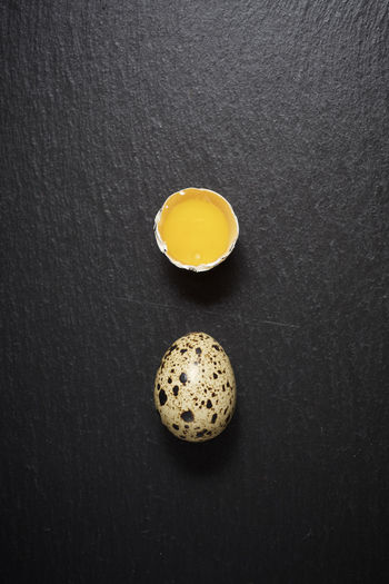 Quail eggs on a black table.