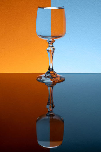 Close-up of light bulb on table against orange background