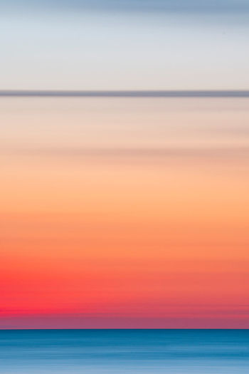 Long exposure, motion blur shot of the sun setting above the baltic sea.