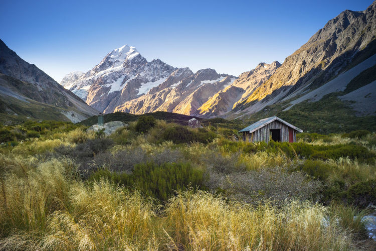 Scenic view of field and mountains against sky