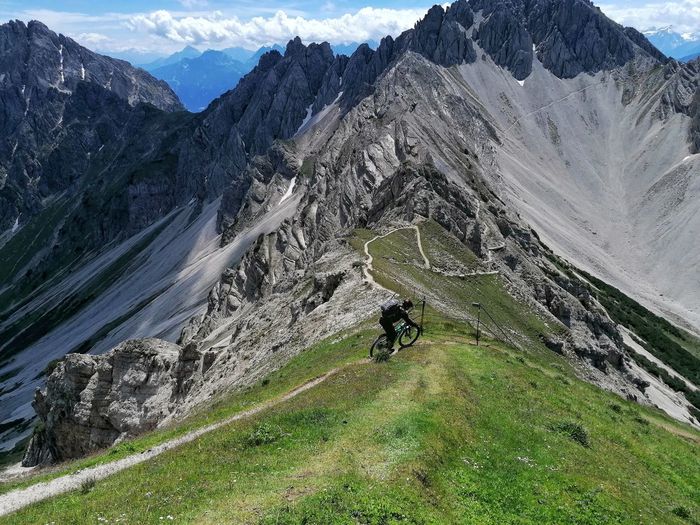 Woman riding the bike on mountain range