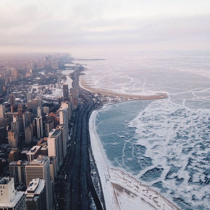 Aerial view of cityscape by frozen sea