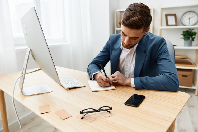 Side view of man working on table