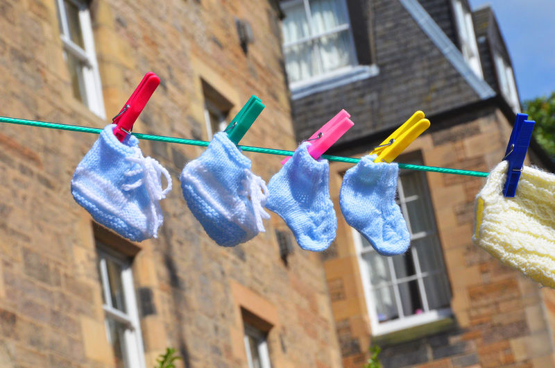 Low angle view of baby socks drying on clothesline