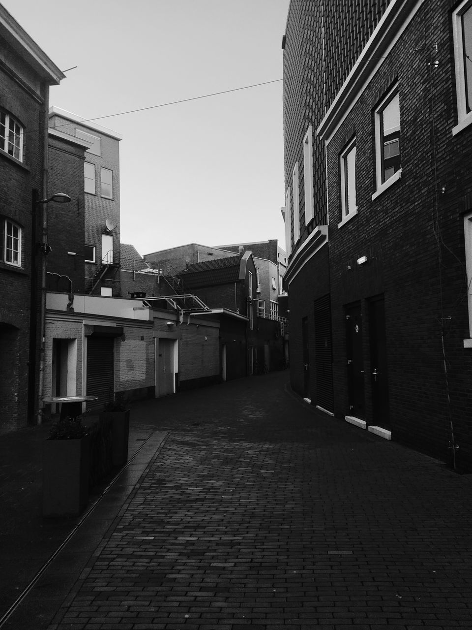 EMPTY ALLEY AMIDST BUILDINGS
