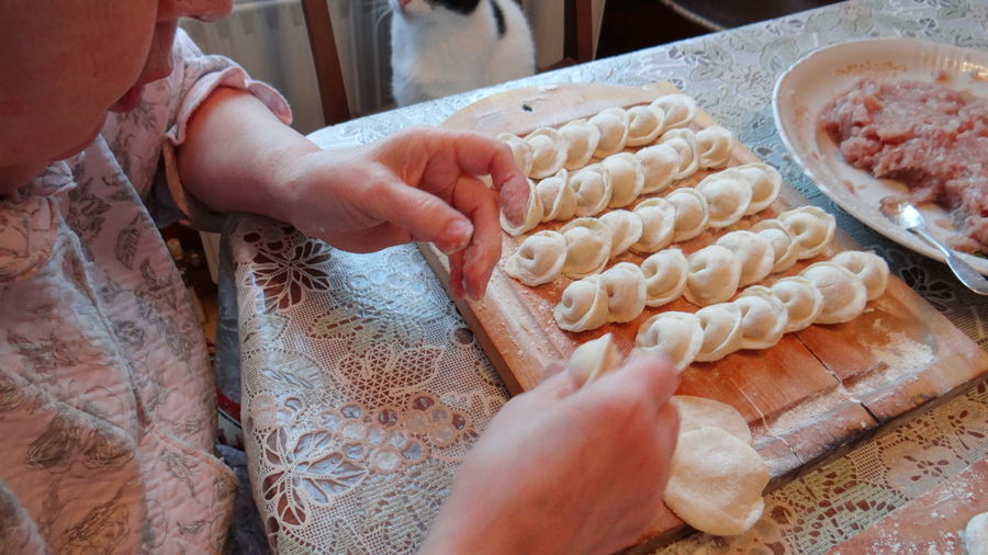 Cropped image of woman preparing dumplings at home