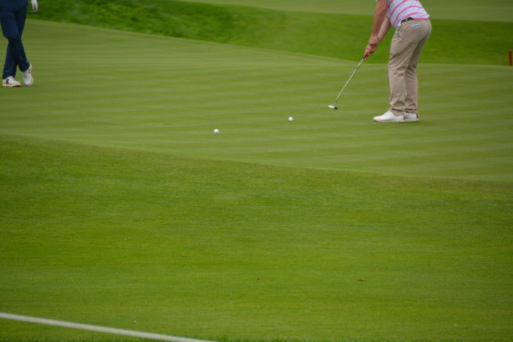 Low section of man playing on golf course
