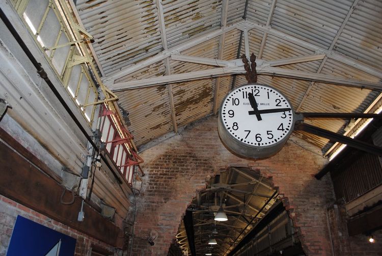 Low angle view of clock hanging at railroad station