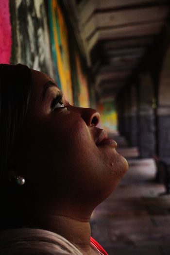 Close-up portrait of young woman looking away