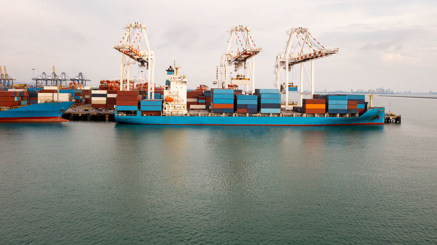 Container ship at industrial port in import export global business services logistic 