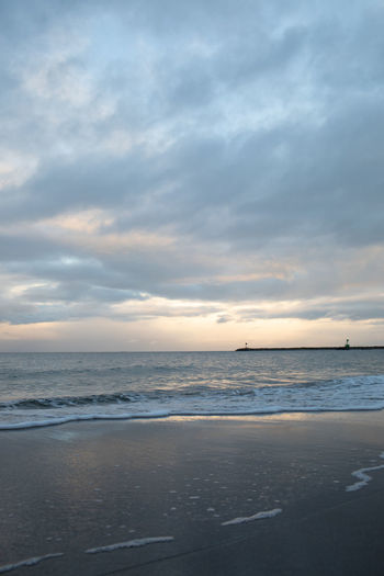 Scenic view of beach against sky during sunset