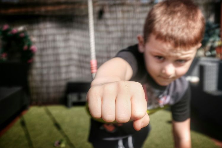 Portrait of boy showing fist