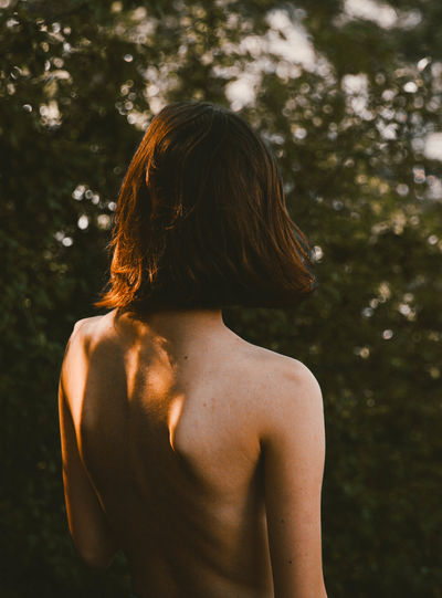 Adult Beauty In Nature Day Focus On Foreground Hair Hairstyle Human Back Human Hair Leisure Activity Lifestyles Nature Nüde Art. One Person Outdoors Plant Real People Rear View Semi-dress Shirtless Standing Sunlight Tree Waist Up Week On Eyeem Young Adult