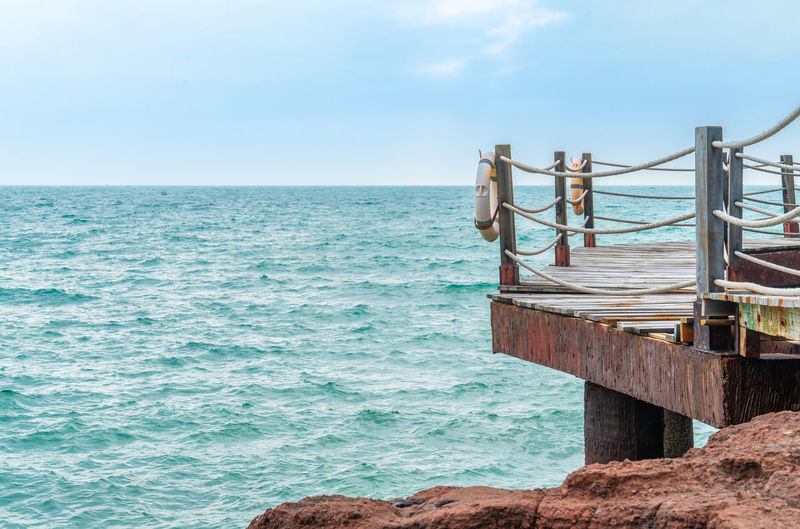 Rock and wood bridge by the sea