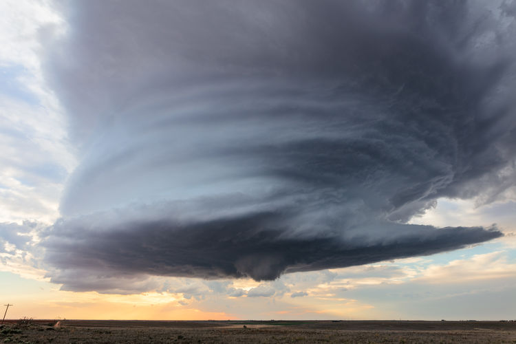 A supercell thunderstorm spins over a field near earth, texas