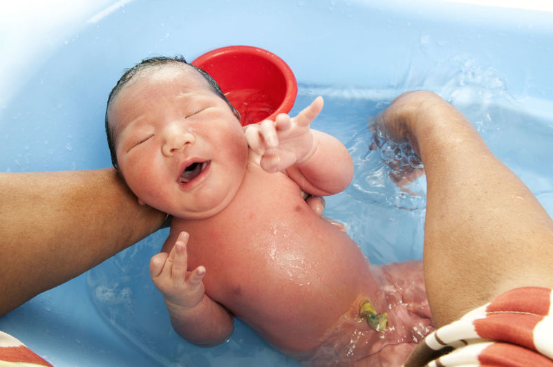 Midsection of baby girl in swimming pool