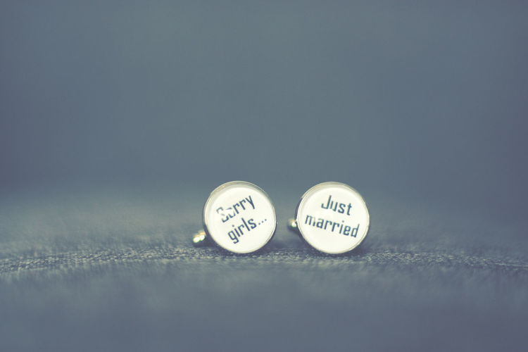 Close-up of text on cuff links