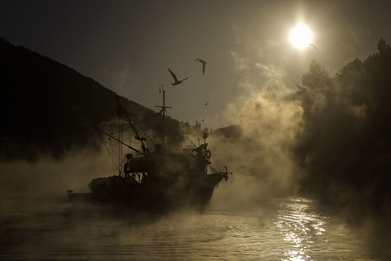 Fishing boat on foggy morning