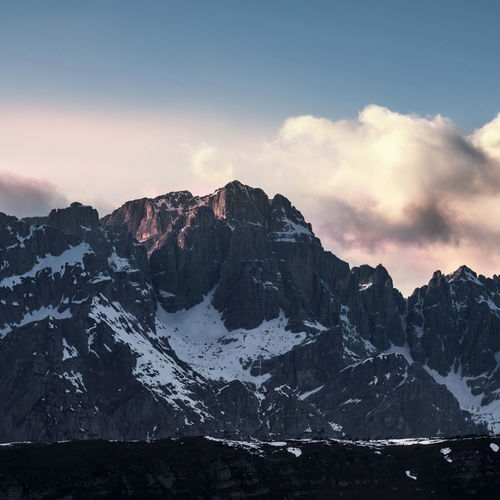 Scenic view of snowcapped mountains against sky during sunset