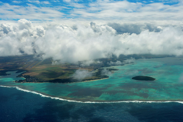 Aerial view of seascape against cloudy sky