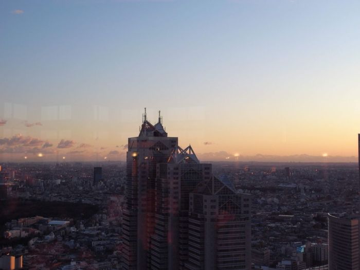 Buildings in city against sky during sunset