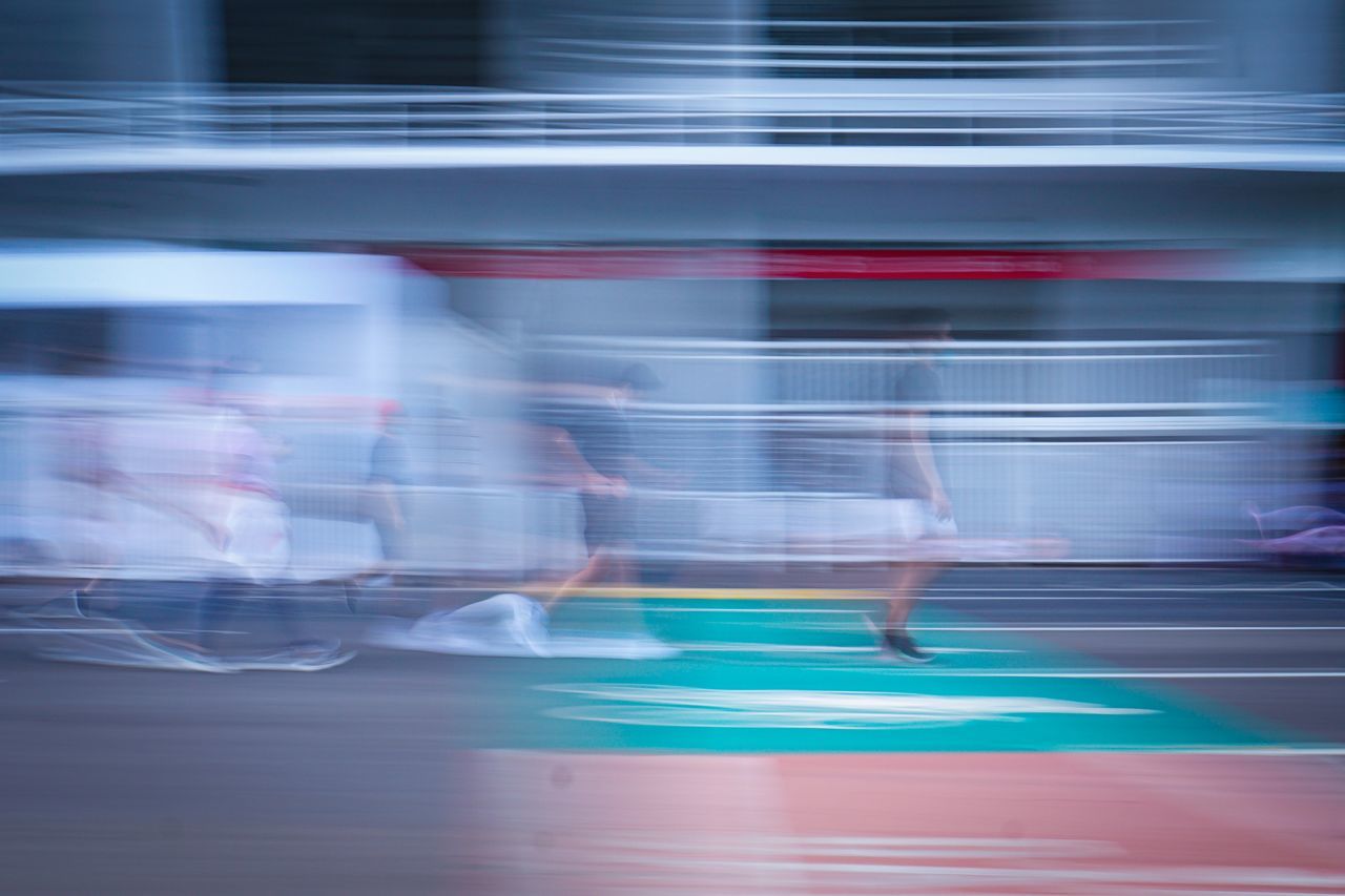 BLURRED MOTION OF TRAIN AT CITY STREET