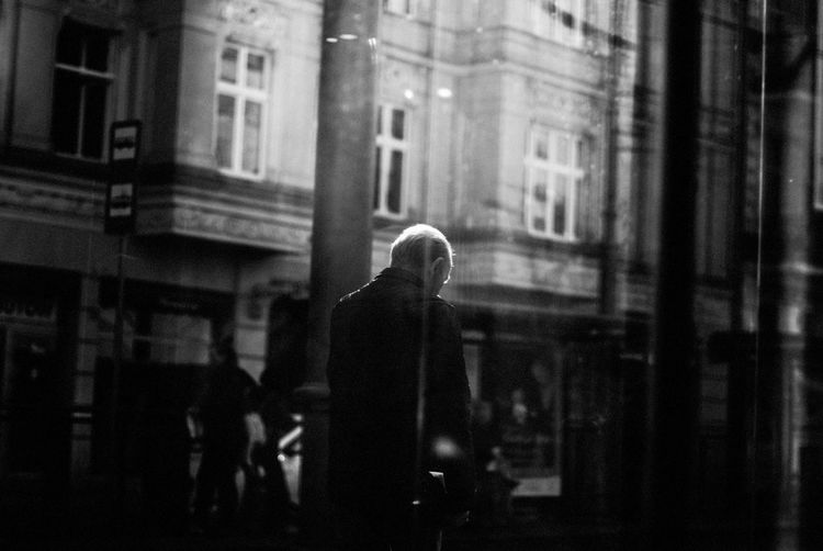 Man seen through window