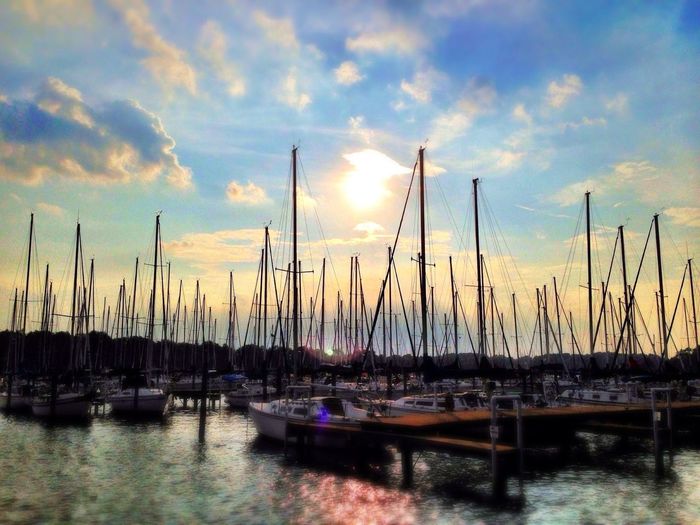 Boats in harbor at sunset