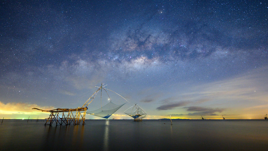Milky way and square dip nets in lake at pakpra, phatthalung, thailand