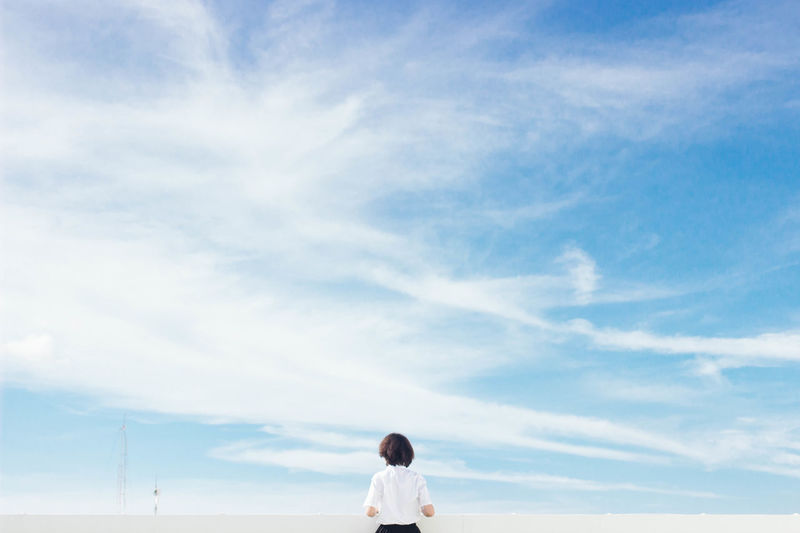 Rear view of woman against sky