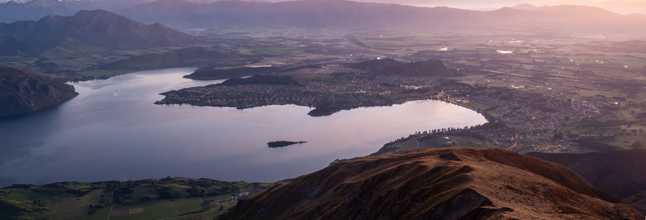 View on valley with lake during sunrise. shot made on roys peak summit in wanaka, new zealand