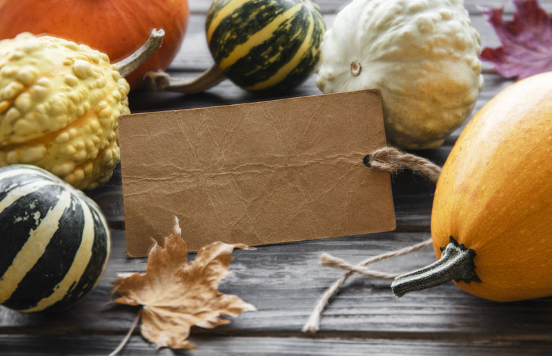 Autumn composition, cozy fall season, pumpkins and leaves on wooden background. 