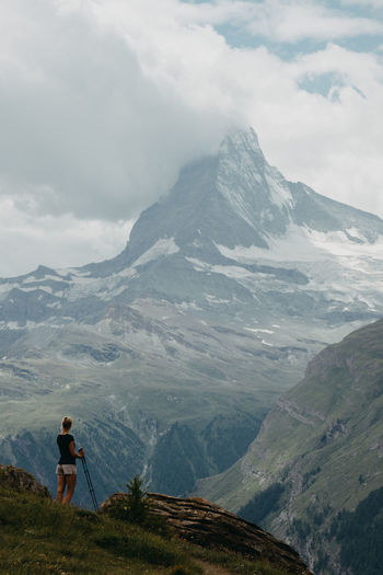 Rear view of woman standing on mountain