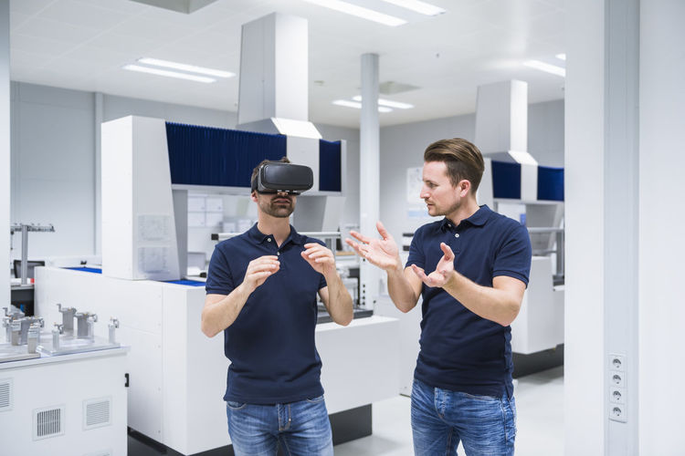 Two men in testing instrument room with vr glasses